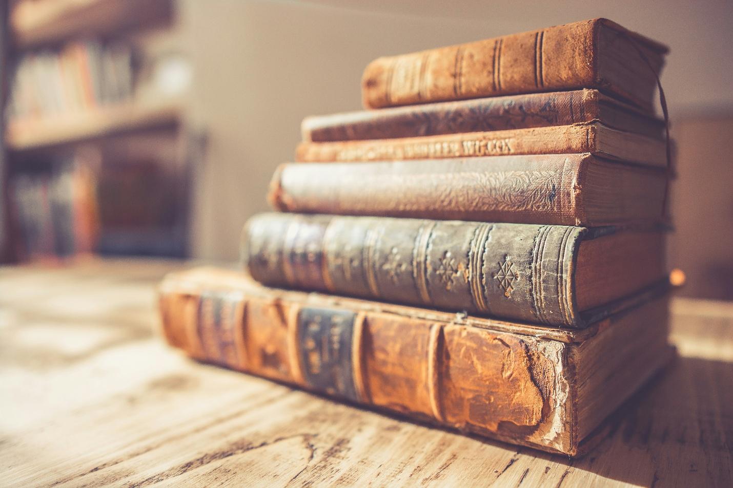 A stack of old booksAI-generated content may be incorrect.