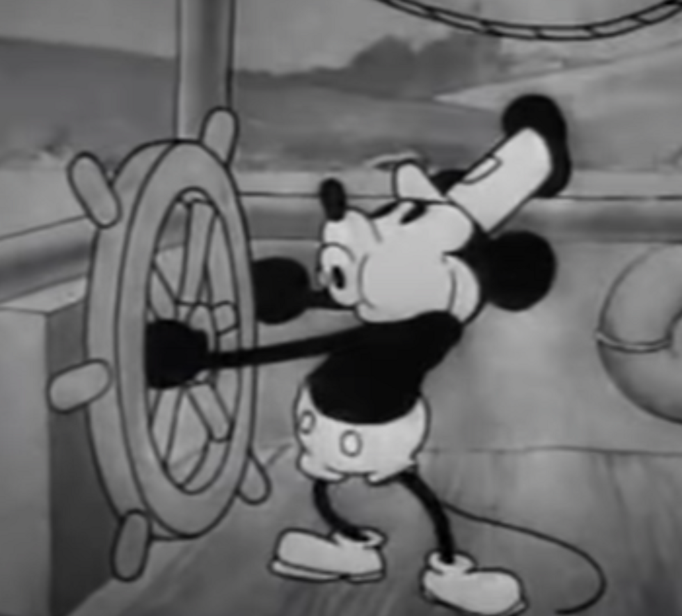Micky Mouse grabbing the wheel in steamboat willie